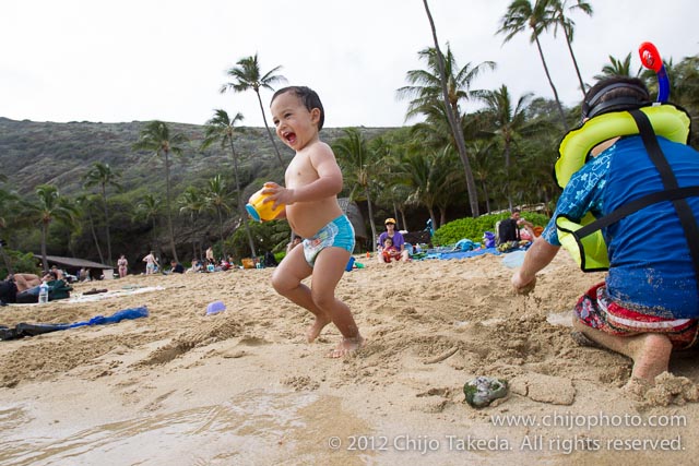 Toddler playing on beach at Hanauma Bay, Oahu, Hawaii
